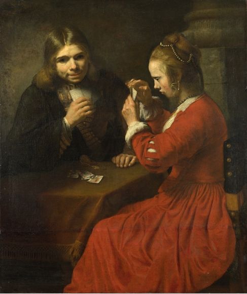 Молодой человек и девочка играют в карты